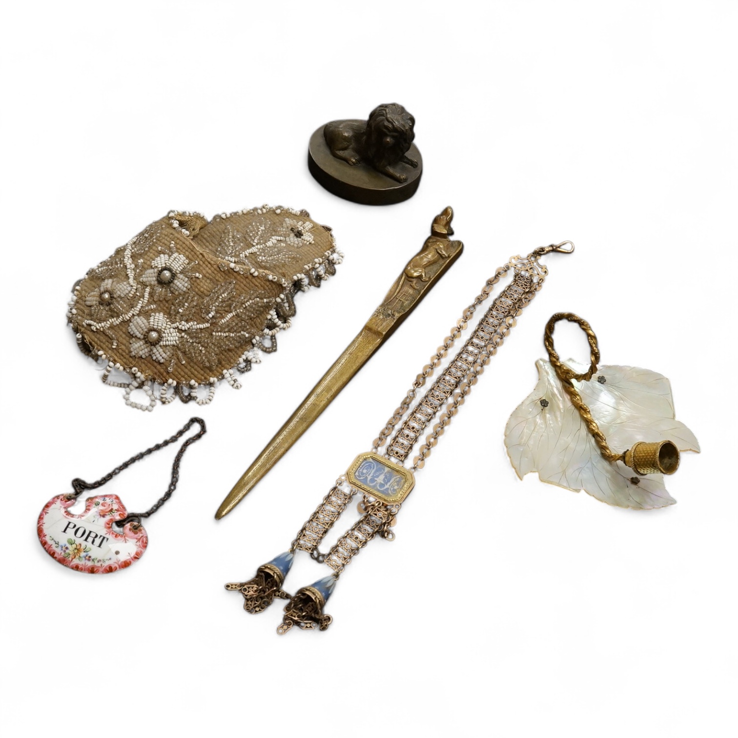 19th century objects to include a bronze lion paperweight, a Palais Royale chamberstick, a beadwork pocket, chatelaine etc